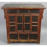 A Chinese hardwood dwarf cabinet enclosed by a pair of panel doors, 38” wide x 37” high x 20½”