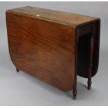 A 19th century mahogany drop-leaf dining table with rounded corners to the rectangular top, & on