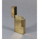 A Dupont of Paris gold plated cigarette lighter (No. 4330L).