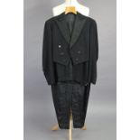 A black dinner jacket with matching trousers tailored by Kilgour, French, & Stanbury Ltd. of Savill