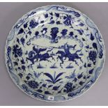 A Chinese porcelain large dish with blue & white decoration of warriors to centre, 24” diameter;