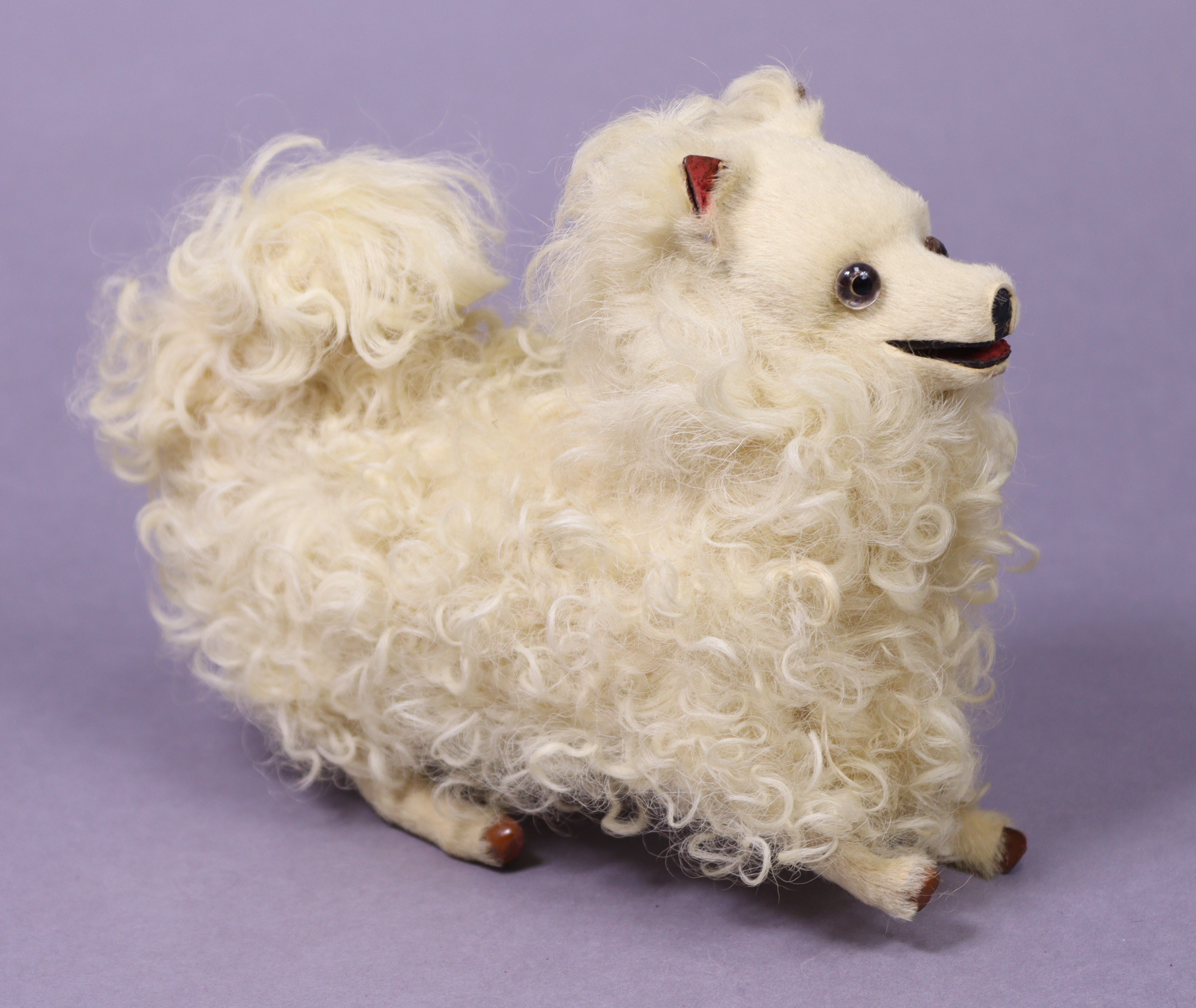 A VINTAGE FRENCH(?) JUMPING POODLE AUTOMATON TOY with white fur & spring clockwork-operated