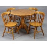 A beech-finish circular extending dining table, with centre leaf & on vase-turned centre column &