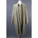 A Burberry cream coloured overcoat with plaid lining, 100% cotton; shoulder width 17”, length