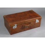 A vintage tan leather suitcase fitted chrome twin-lever locks, 29½” wide x 10½” high x 17” deep.