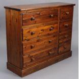 A pine chest, fitted two ranks of four long drawers with turned knob handles, & on plinth base, 52”
