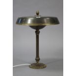 A bronzed table lamp on a fluted centre column & circular base, with shade, 20” high.