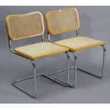 A pair of Bauhaus style chrome-plated & wooden kitchen chairs each with a woven-cane seat & back.