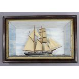 A 19TH CENTURY PAINTED WOODEN SAILING SHIP DIORAMA with a painted background & in a simulated walnut