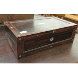 A late Regency rosewood writing box with carved bead bordered ornament, the angled,