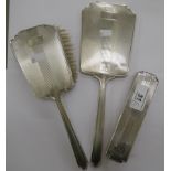 Three Art Deco silver backed dressing table items, viz.