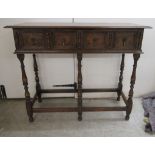 A 1930s oak side table, comprising two frieze drawers, raised on turned,