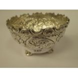 A modern Indian silver coloured metal footed bowl of ogee form,