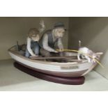 A Lladro porcelain group, two figures in a fishing boat, model.no.