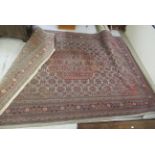 A Persian carpet, decorated with repeating stylised designs,