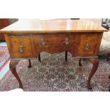 A 1920s Queen Anne inspired figured walnut kneehole desk,