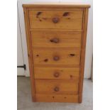 A modern honey coloured pine, five drawer pedestal chest,