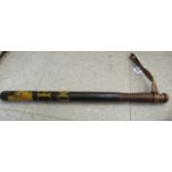 A late 19thC painted wooden truncheon, having a tapered shaft, a rib carved,