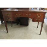 A 1920/30s mahogany four drawer kneehole desk, raised on square,