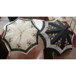 Two similar Edwardian parasols with painted shafts and lined,