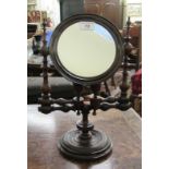 An early 20thC dressing table mirror, the circular plate set in a bobbin turned,