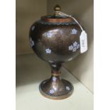 An early 20thC Chinese cloisonne jar of bulbous form, having a cover and knop,