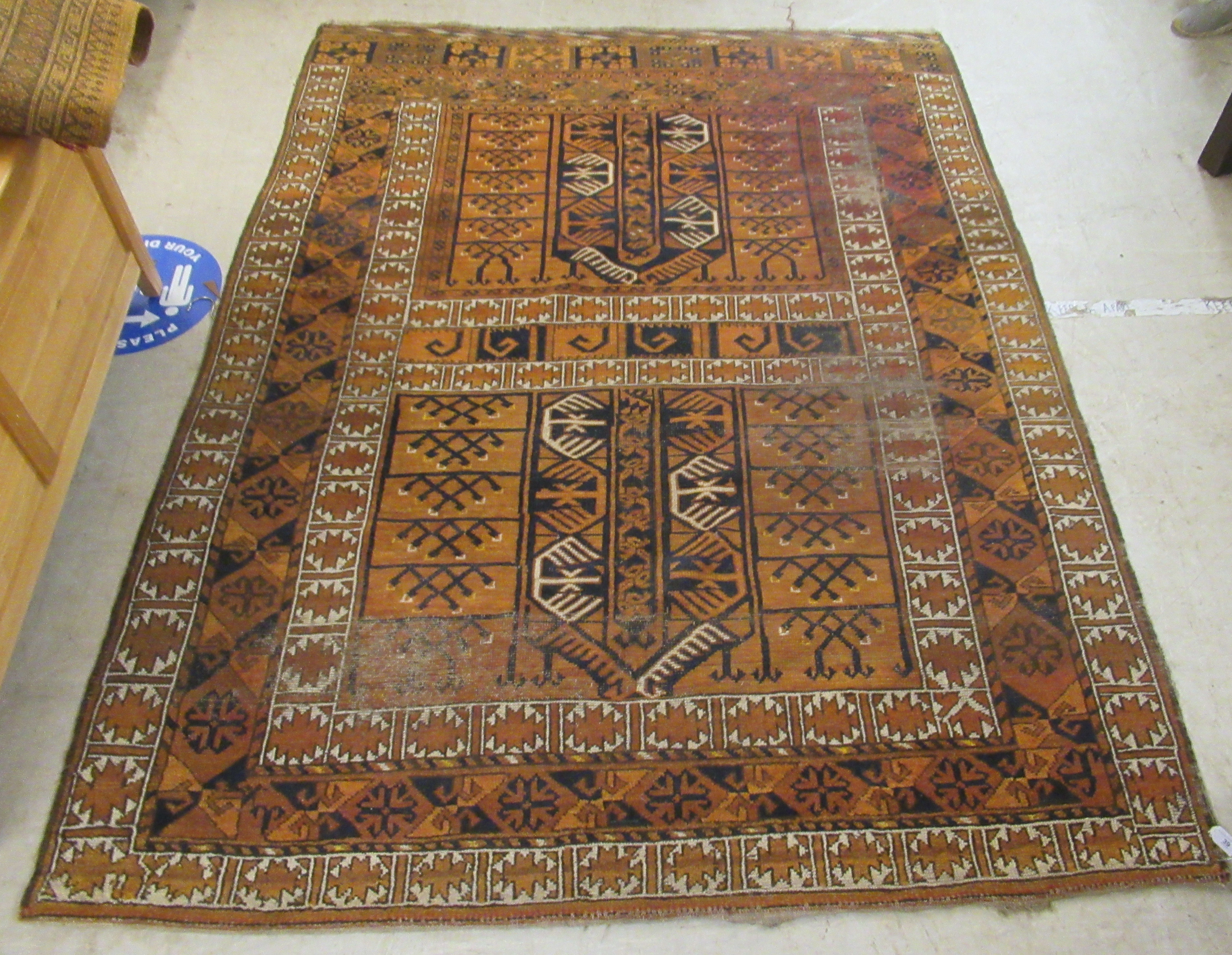 A Caucasian rug, decorated with repeating stylised designs,