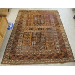 A Caucasian rug, decorated with repeating stylised designs,