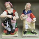 A pair of late Victorian Staffordshire pottery figures,