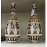 A pair of late Victorian Doulton Lambeth ovoid shaped stoneware bottle vases with applied silver