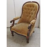 A late Victorian mahogany spoonback nursing chair, button upholstered in gold coloured fabric,