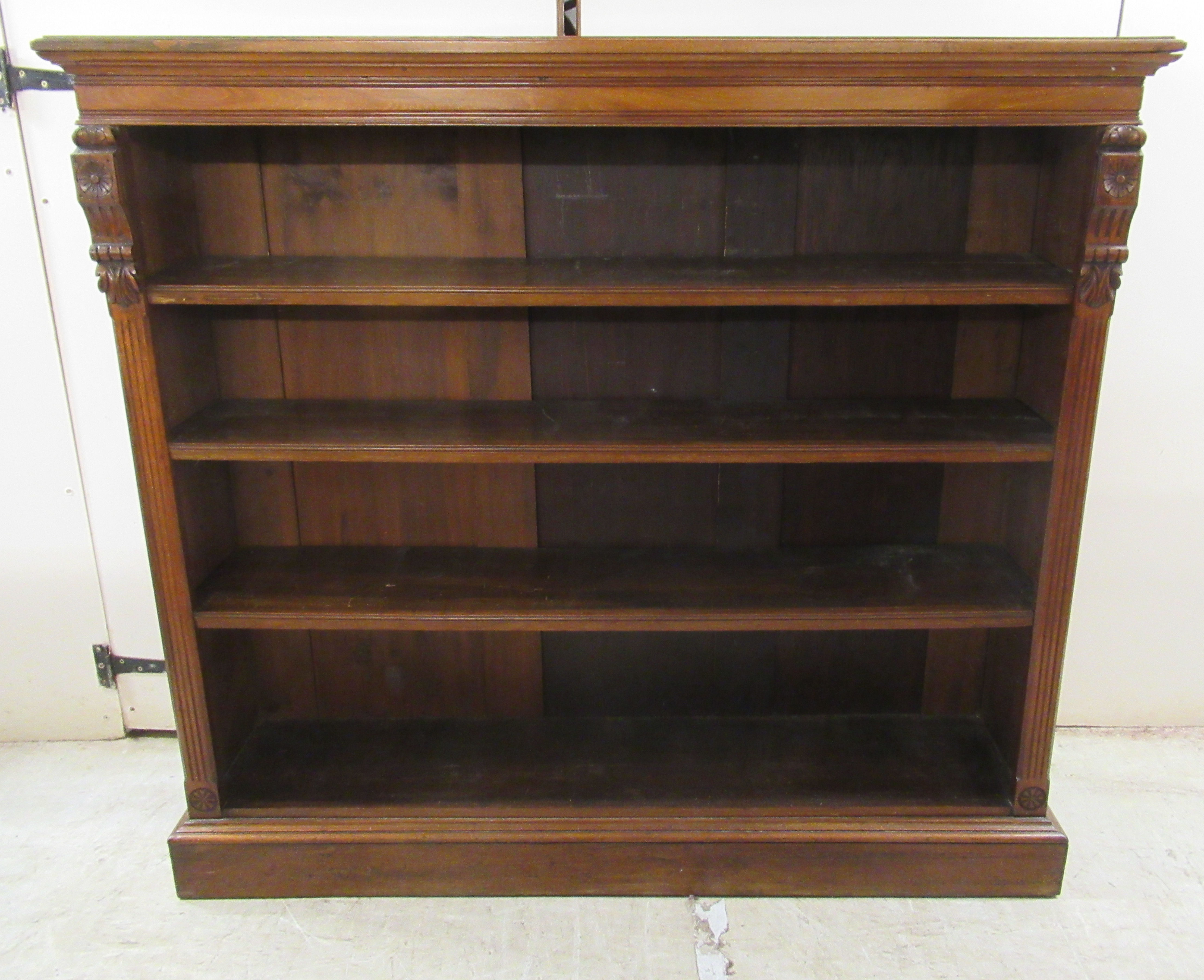 A late Victorian mahogany open front dwarf bookcase with three shelves,