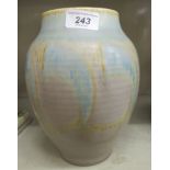 A Pilkingtons Royal Lancastrian pottery ribbed baluster shaped vase, decorated in tones of blue,