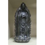 A 19thC Chinese carved black jade or hardstone standing flatback figure,