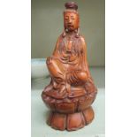 A 19thC carved boxwood or similar seated figure of Guan Yin OS1