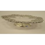 A silver comport, the wide border cast, pierced and engraved with fruiting vines,