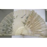 A late 19thC fan with decoratively painted carved bone pierced sticks 14''L;