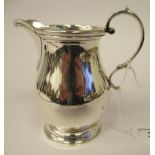 A Georgian style silver baluster shaped cream jug with an applied wire border and double C-scrolled