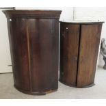 A George III oak quadrant corner cabinet with a pair of doors, on a plinth 41.5''h 28.