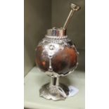 A South American silver coloured metal mounted calabash gourd mate cup of pedestal design with an