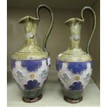 A pair of Royal Doulton green and blue glazed stoneware ewers of ovoid form,