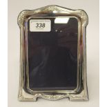 A modern Victorian style, glazed silver photograph frame, the border with embossed ornament,
