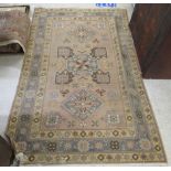 A Caucasian rug, decorated with repeating geometric and stylised designs,