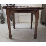 An Edwardian string and marquetry mahogany occasional table, the oval top with a galleried,