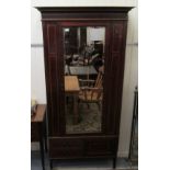 An Edwardian string and ebony crossbanded mahogany wardrobe with a moulded cornice,