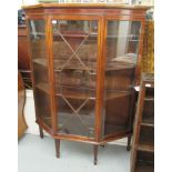 An Edwardian crossbanded and string inlaid mahogany breakfront display cabinet with a central door,