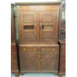 A George III oak food cupboard, the upper section with two ventilated panelled doors,