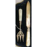 An Edwardian silver bread fork and knife, variously engraved with scrolled and other designs,