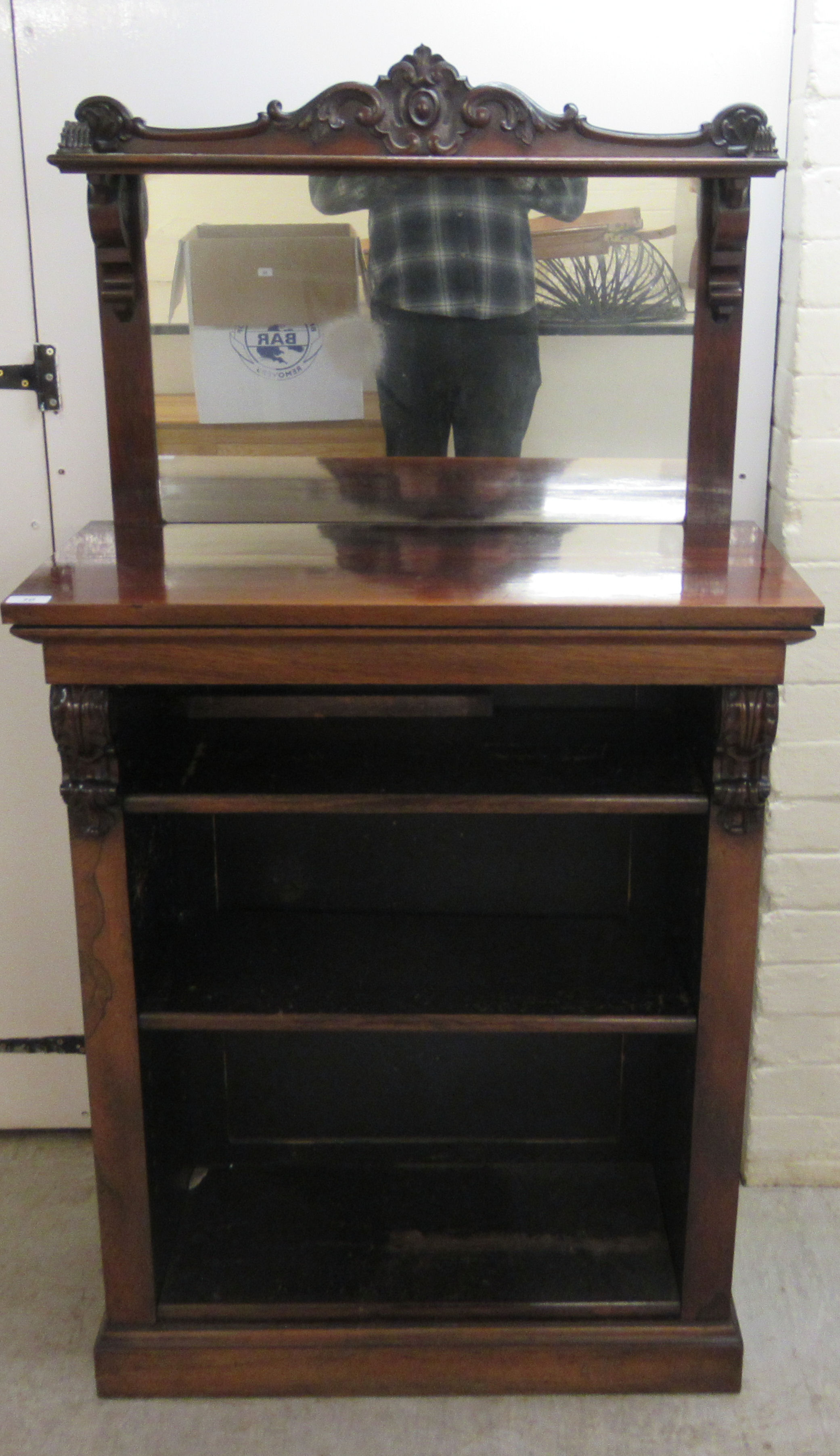 A mid Victorian rosewood chiffonier with a mirrored back, over two open front shelves,