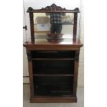 A mid Victorian rosewood chiffonier with a mirrored back, over two open front shelves,